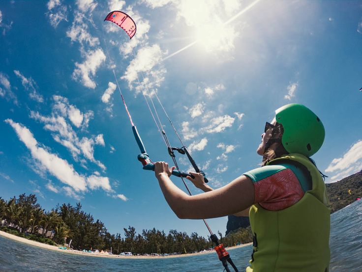 A kitesurfer catching air above the waves on Paje Beach, Zanzibar."
"Beginner kitesurfing lesson at Paje Beach, with an instructor guiding a student in shallow waters."
"A panoramic view of Paje Beach, Zanzibar, with kitesurfers in the distance and turquoise waters meeting the sandy shore."
"Palm trees lining the white sandy shores of Zanzibar Island under a clear, sunny sky."
"The entrance of a kitesurf school in Paje, Zanzibar, featuring surfboards and kites ready for lessons."
"A group of kitesurfing students preparing their kites on the beach at a kitesurf school in Zanzibar."
"Traditional dhow sailing near the coast of Zanzibar Island at sunset, reflecting the island’s rich cultural heritage."
"Stone Town’s vibrant market, showcasing the cultural side of Zanzibar, with colorful stalls and local products."