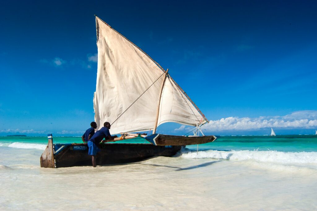 Kitesurfer practicing intermediate tricks on the deeper waters of Jambiani Beach, Zanzibar.