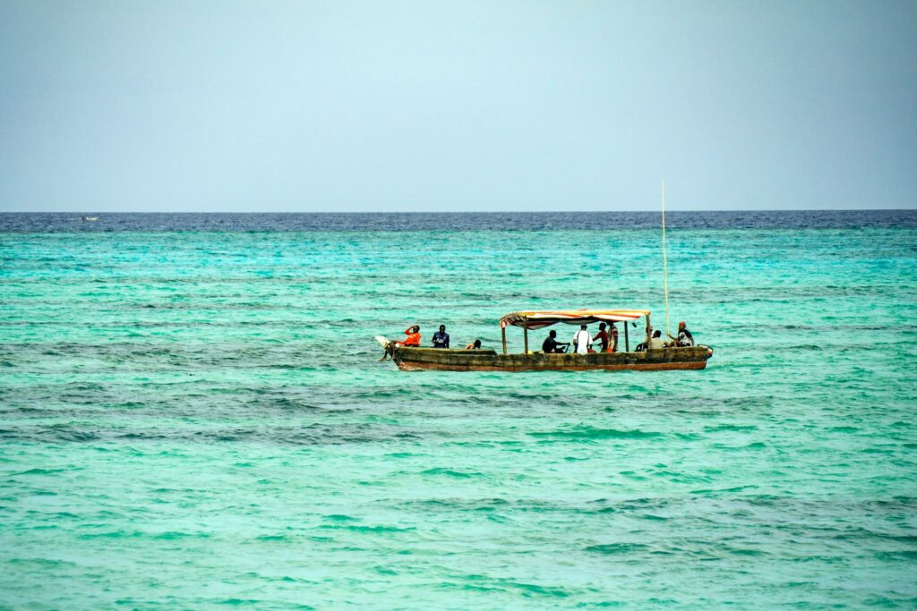 Kitesurfer enjoying the calm waters of Matemwe Beach, with the reef break visible in the distance.